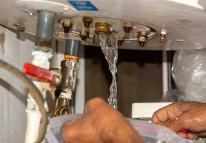 A man repairs a water heater, ensuring the proper functioning of the device that provides hot water.