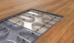 A metal floor heating system installed on a wooden floor.