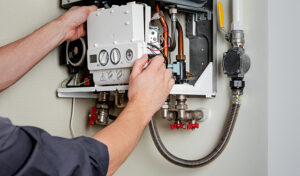 A man skillfully repairing a gas boiler with focused concentration and specialized tools