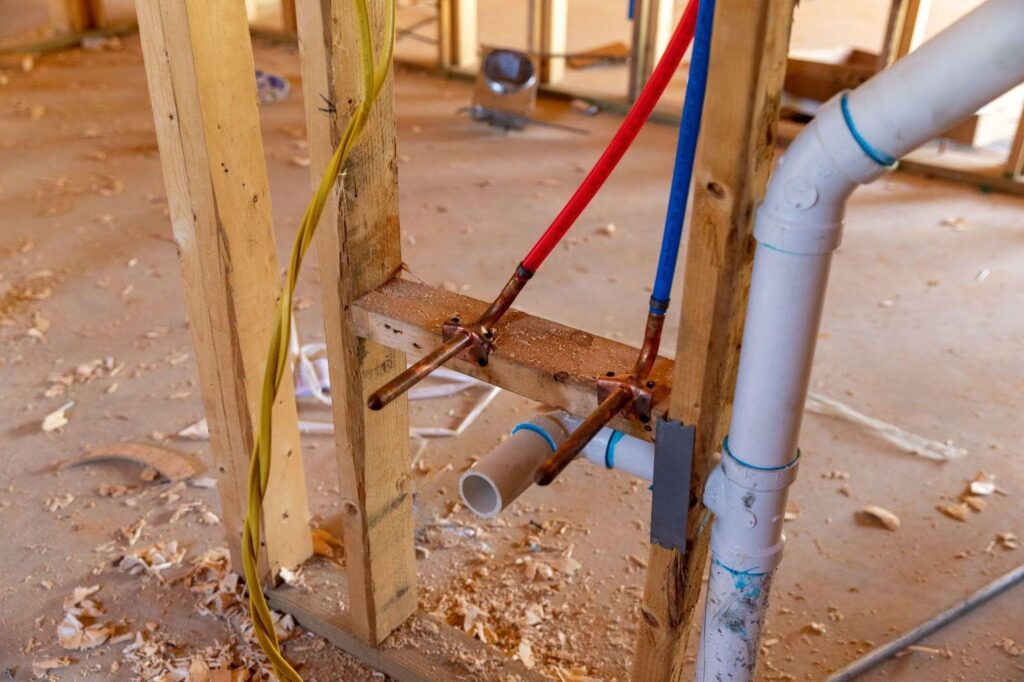 A pipe and hose are attached to a wall indicating a connection for water or air flow
