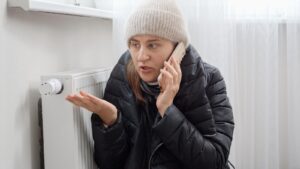 A woman wearing a beanie is talking on her cell phone appearing engaged in conversation